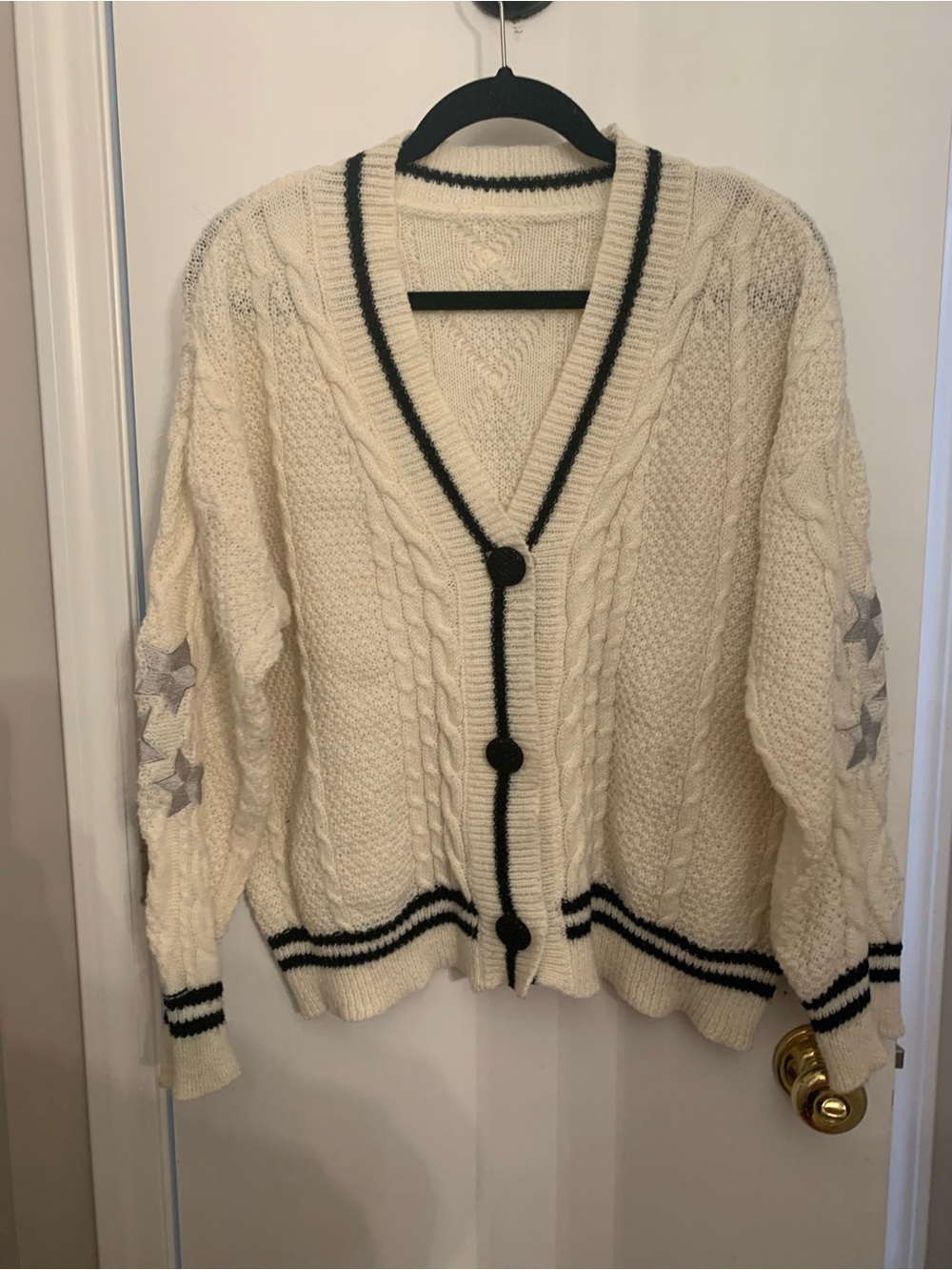 Cream Cable-Knit Cardigan with Black Trim and Star Sleeve Detail